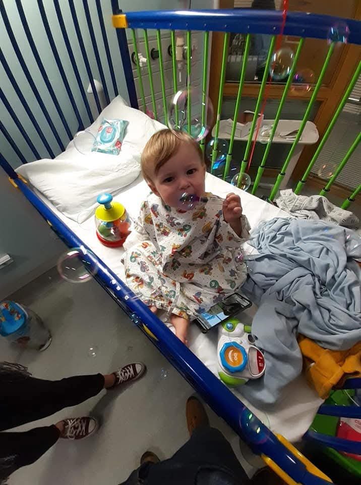 Baby boy in cot in hospital