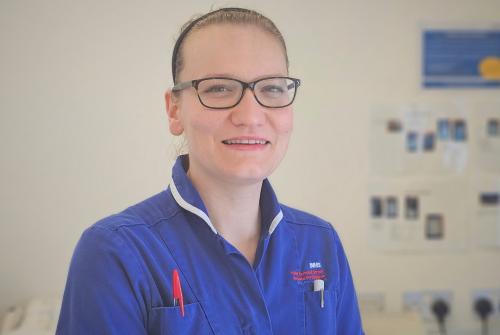Sarah at GOSH in the middle of a clinic room with some medical devices in the background
