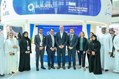 Members of GOSH and Burjeel Holdings are stood in with copies of signed MoU in a celebratory photo following the MoU signature.